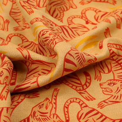 Seamless illustrative pattern featuring leaping red tigers on a warm peach-toned background.