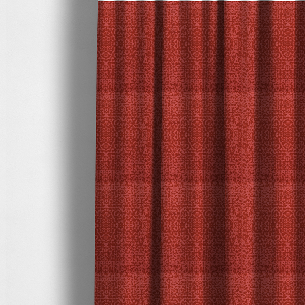 The fabric used to create these made-to-measure curtains is a distressed terracotta red fabric with a symmetrical, abstract medallion pattern and a weathered, block-print texture.