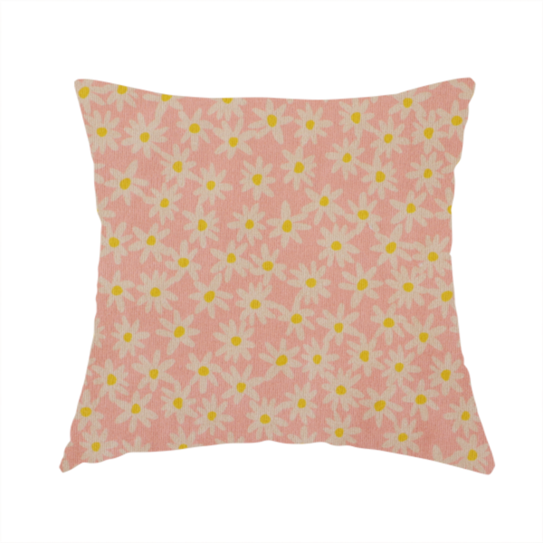 The fabric used to create this handmade cushion has a seamless ditsy floral pattern featuring small white and yellow daisies on a soft peach-pink fabric background.