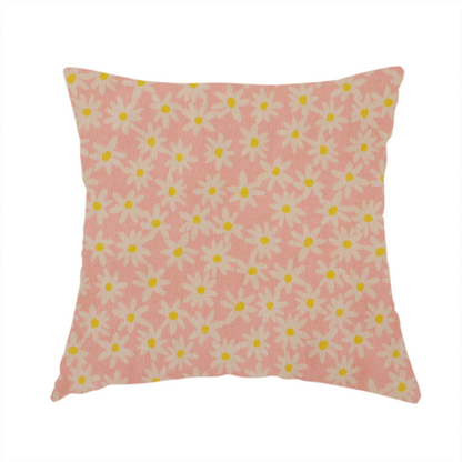 The fabric used to create this handmade cushion has a seamless ditsy floral pattern featuring small white and yellow daisies on a soft peach-pink fabric background.
