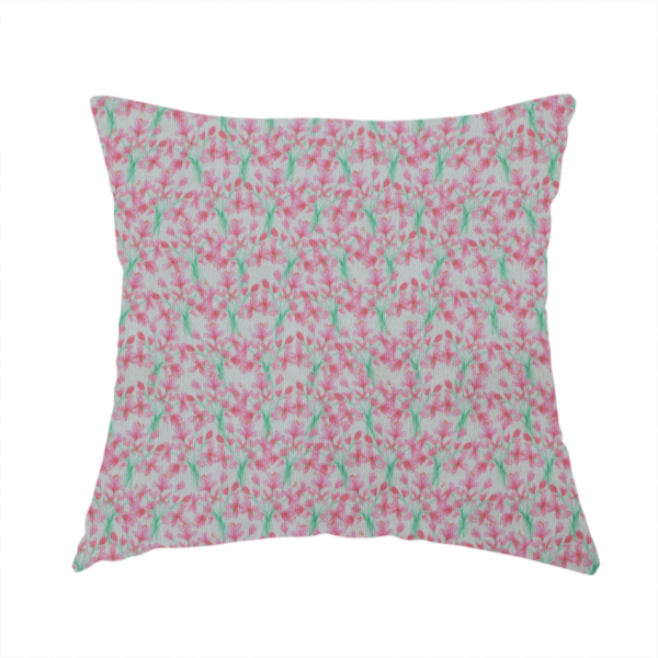 The fabric used to create this handmade cushion has a vertical pink floral branch pattern on white fabric, featuring a delicate blossom and green stem motif.