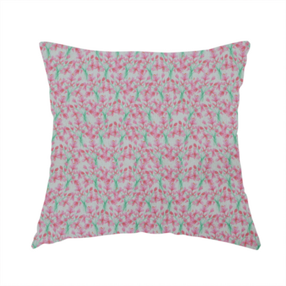 The fabric used to create this handmade cushion has a vertical pink floral branch pattern on white fabric, featuring a delicate blossom and green stem motif.