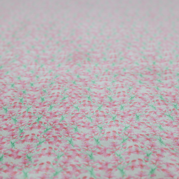 Vertical pink floral branch pattern on white fabric, featuring a delicate blossom and green stem motif.