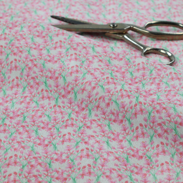 Vertical pink floral branch pattern on white fabric, featuring a delicate blossom and green stem motif.