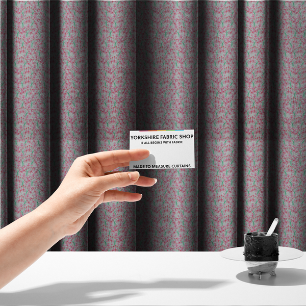 The fabric used to create these made-to-measure curtains has a vertical pink floral branch pattern on white fabric, featuring a delicate blossom and green stem motif.