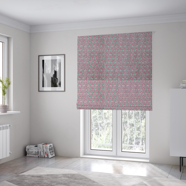 The fabric used to create these Roman blinds has a vertical pink floral branch pattern on white fabric, featuring a delicate blossom and green stem motif.