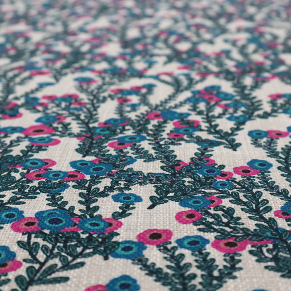 A patterned upholstery fabric with a visible cross-weave texture. The design features a repetitive botanical motif of teal vines and multi-coloured pink and blue flowers on a neutral cream base.
