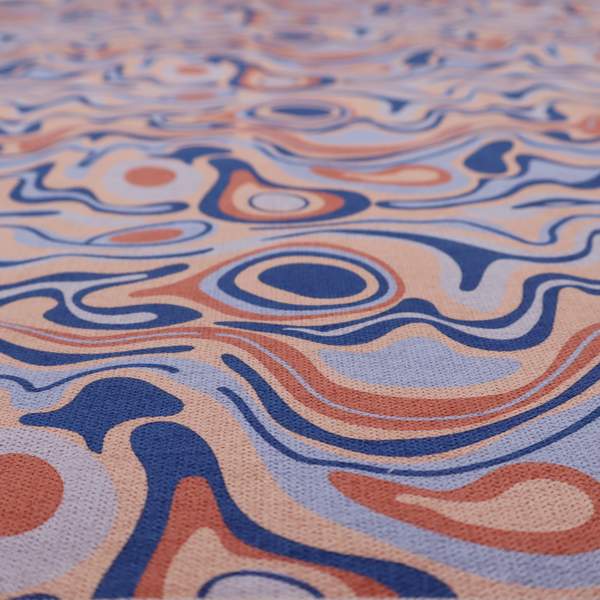 A repeating textile design with a psychedelic, mid-century modern aesthetic. The pattern consists of flowing, organic "liquid" lines and nested concentric shapes resembling a topographical map or marbleized paper. Colours include deep navy blue, warm terracotta, soft peach, and periwinkle.
