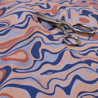 A repeating textile design with a psychedelic, mid-century modern aesthetic. The pattern consists of flowing, organic "liquid" lines and nested concentric shapes resembling a topographical map or marbleized paper. Colours include deep navy blue, warm terracotta, soft peach, and periwinkle.