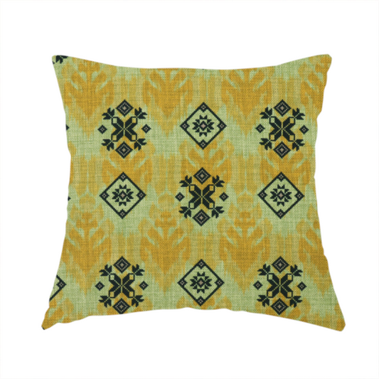 The fabric used to create this handmade cushion has a seamless geometric pattern featuring black and charcoal medallions over a textured yellow and olive green ikat background.