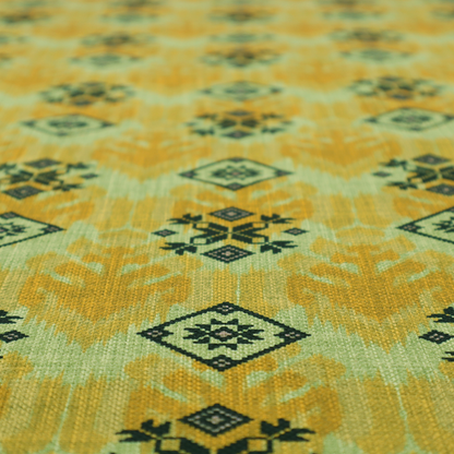 Seamless geometric pattern featuring black and charcoal medallions over a textured yellow and olive green ikat background.