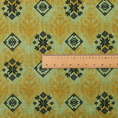 Seamless geometric pattern featuring black and charcoal medallions over a textured yellow and olive green ikat background.