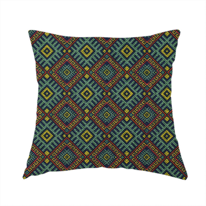 The fabric used to create this handmade cushion is a detailed woven fabric featuring a repeating geometric diamond lattice pattern in shades of teal, mustard yellow, and terracotta red.