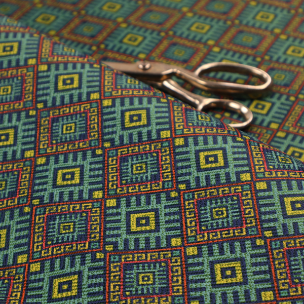 A detailed woven fabric featuring a repeating geometric diamond lattice pattern in shades of teal, mustard yellow, and terracotta red.