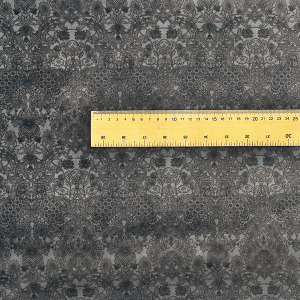 Vintage-inspired charcoal damask upholstery fabric. Ornate baroque floral pattern on a distressed slate grey background, suitable for gothic or French country home decor.