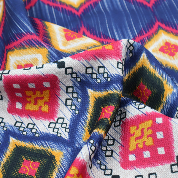 A high-energy textile with a large-scale geometric Ikat design. The pattern showcases concentric diamonds with feathered, "blurred" edges in electric blue, bright pink, and yellow, set against a background with vertical white striations.