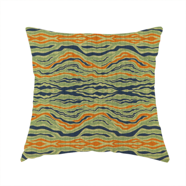 The fabric used to create this handmade cushion is a woven fabric featuring a repeating horizontal wavy pattern in burnt orange, navy blue, and sage green.