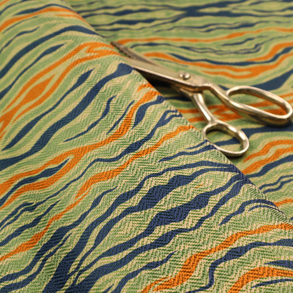 A woven fabric featuring a repeating horizontal wavy pattern in burnt orange, navy blue, and sage green.