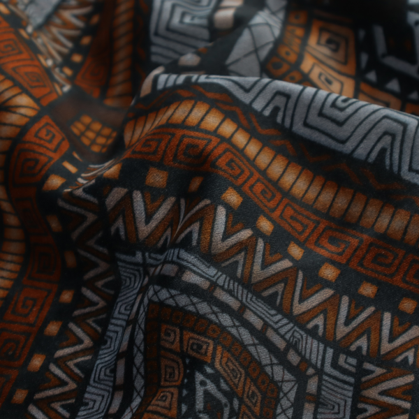 Intricate textile design with a repeating diamond and chevron motif. The pattern features fine, hand-inked linework, including Greek key patterns and zig-zags. The colour palette is a moody mix of earthy terracotta, deep grey, and black, giving it a rustic, bohemian feel.