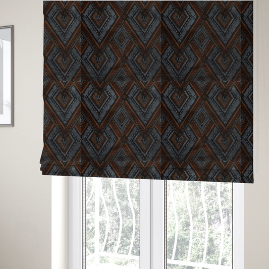The fabric used to create these bespoke Roman blinds is a intricate textile design with a repeating diamond and chevron motif. The pattern features fine, hand-inked linework, including Greek key patterns and zig-zags. The colour palette is a moody mix of earthy terracotta, deep grey, and black, giving it a rustic, bohemian feel.