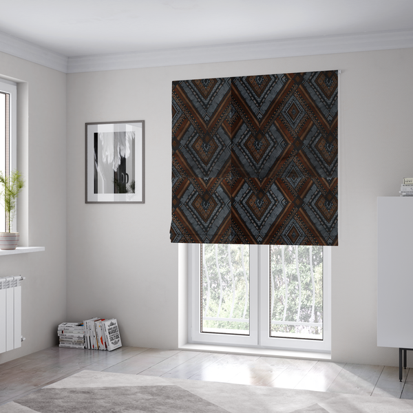 The fabric used to create these bespoke Roman blinds is a intricate textile design with a repeating diamond and chevron motif. The pattern features fine, hand-inked linework, including Greek key patterns and zig-zags. The colour palette is a moody mix of earthy terracotta, deep grey, and black, giving it a rustic, bohemian feel.