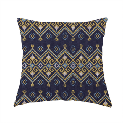 The fabric used to create this handmade cushion is a horizontal Southwestern-inspired geometric pattern featuring navy blue bands with mustard yellow and sky blue interlocking diamonds and Greek key motifs.