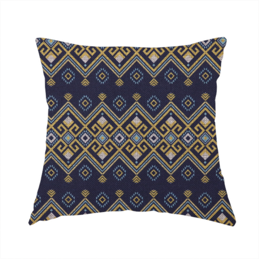 The fabric used to create this handmade cushion is a horizontal Southwestern-inspired geometric pattern featuring navy blue bands with mustard yellow and sky blue interlocking diamonds and Greek key motifs.