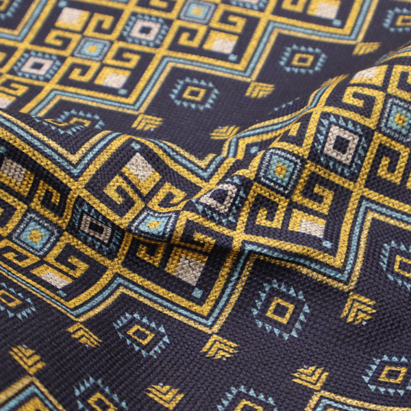 A horizontal Southwestern-inspired geometric pattern featuring navy blue bands with mustard yellow and sky blue interlocking diamonds and Greek key motifs.
