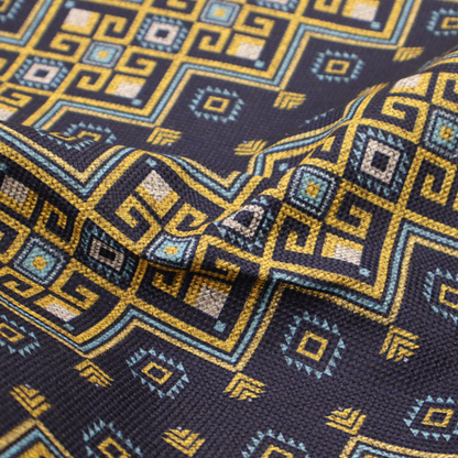 A horizontal Southwestern-inspired geometric pattern featuring navy blue bands with mustard yellow and sky blue interlocking diamonds and Greek key motifs.