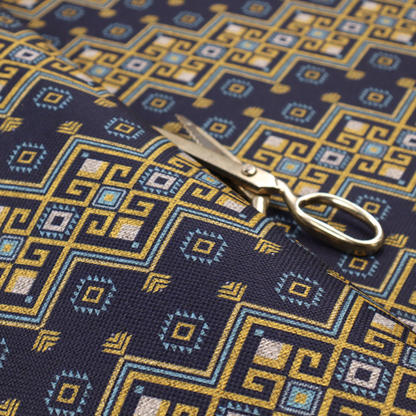 A horizontal Southwestern-inspired geometric pattern featuring navy blue bands with mustard yellow and sky blue interlocking diamonds and Greek key motifs.
