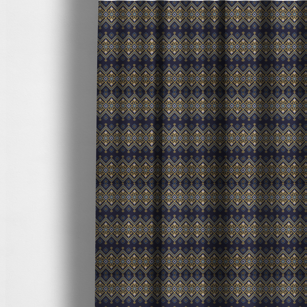 The fabric used to create these made-to-measure curtains is a horizontal Southwestern-inspired geometric pattern featuring navy blue bands with mustard yellow and sky blue interlocking diamonds and Greek key motifs.