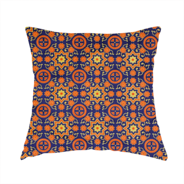 The fabric used to create this cushion is a repeating celestial geometric pattern featuring eight-pointed orange stars and circular cross motifs set against a deep navy blue background with yellow filigree.