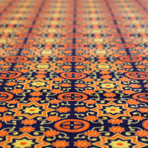 A repeating celestial geometric pattern featuring eight-pointed orange stars and circular cross motifs set against a deep navy blue background with yellow filigree.