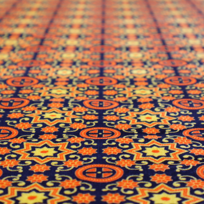 A repeating celestial geometric pattern featuring eight-pointed orange stars and circular cross motifs set against a deep navy blue background with yellow filigree.