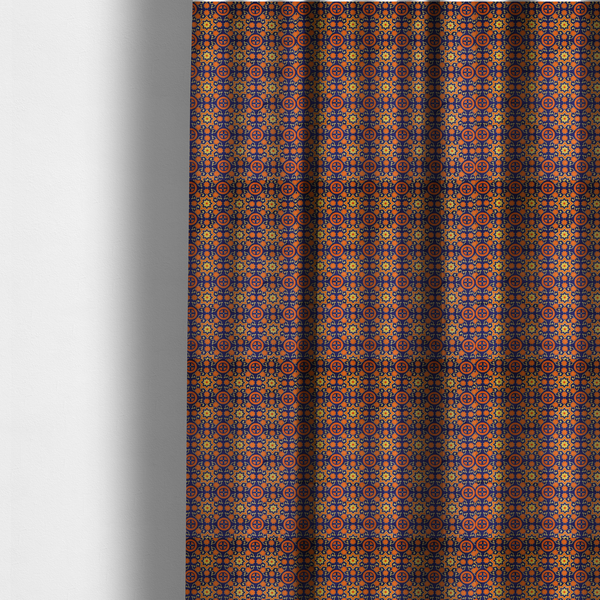 The fabric used to create these made-to-measure curtains is a repeating celestial geometric pattern featuring eight-pointed orange stars and circular cross motifs set against a deep navy blue background with yellow filigree.