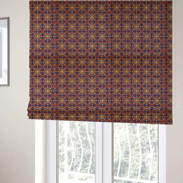 The fabric used to create these Roman blinds is a repeating celestial geometric pattern featuring eight-pointed orange stars and circular cross motifs set against a deep navy blue background with yellow filigree.