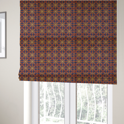 The fabric used to create these Roman blinds is a repeating celestial geometric pattern featuring eight-pointed orange stars and circular cross motifs set against a deep navy blue background with yellow filigree.