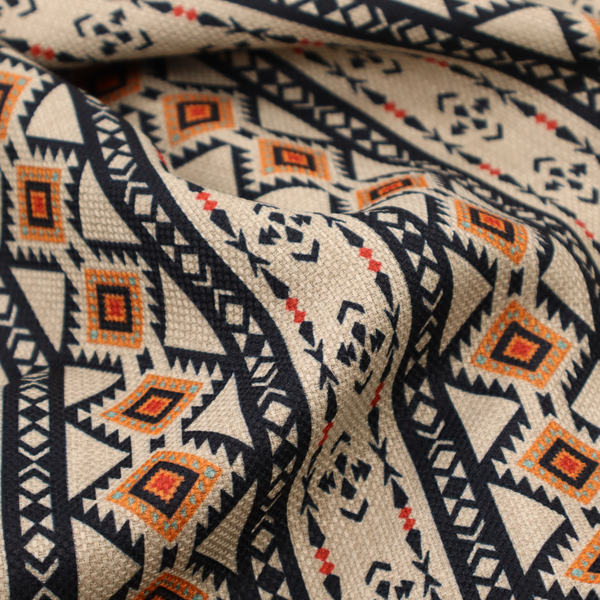 Intricate tribal border print arranged in vertical columns on a visually textured, linen-look base. The design includes repeating rows of rust-orange diamonds, black zig-zags, and arrow-like geometric motifs with a hand-drawn aesthetic.