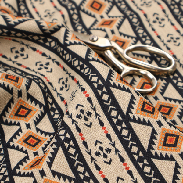 Intricate tribal border print arranged in vertical columns on a visually textured, linen-look base. The design includes repeating rows of rust-orange diamonds, black zig-zags, and arrow-like geometric motifs with a hand-drawn aesthetic.