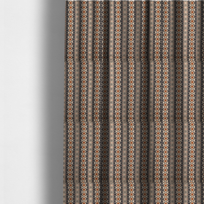 The fabric used to create these made-to-measure curtains is a intricate tribal border print arranged in vertical columns on a visually textured, linen-look base. The design includes repeating rows of rust-orange diamonds, black zig-zags, and arrow-like geometric motifs with a hand-drawn aesthetic.
