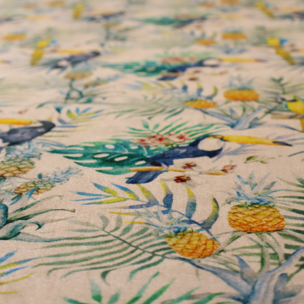 A tropical watercolour pattern featuring perched toucans, parrots, and pineapples surrounded by lush palm leaves on a cream background.