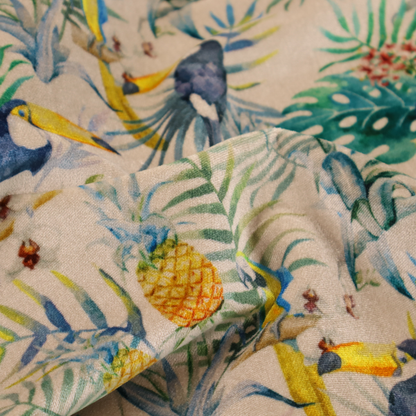 A tropical watercolour pattern featuring perched toucans, parrots, and pineapples surrounded by lush palm leaves on a cream background.