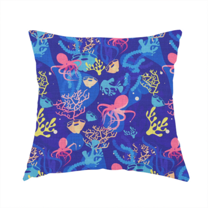 The fabric used to create this handmade cushion is a vibrant nautical pattern featuring pink octopuses, yellow coral branches, and textured sea sponges set against an electric indigo blue background.