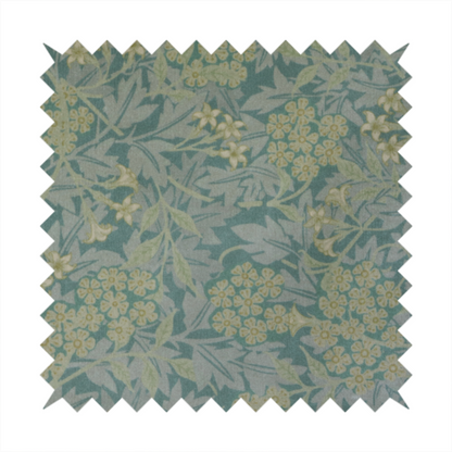 Muted green textile print with a complex, repeating botanical motif. The design features tightly packed five-petal flower clusters and delicate willow-like leaves in shades of dusty sage, teal, and pale lime green.