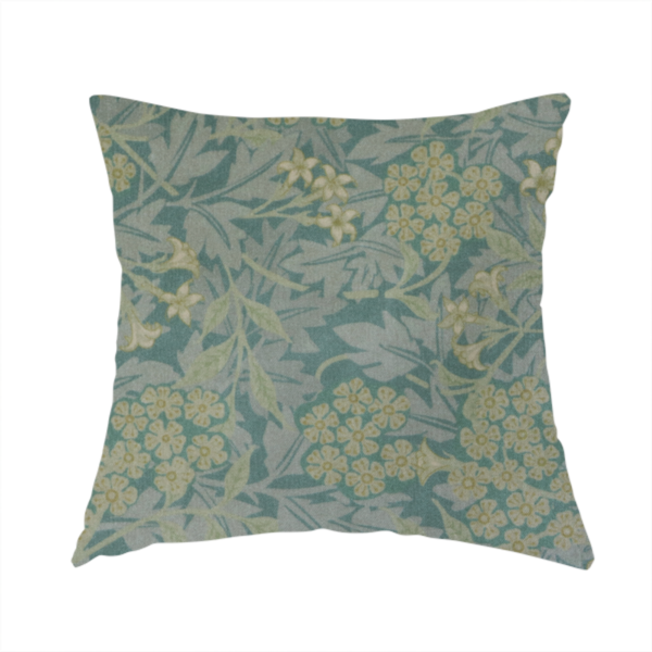 The fabric used to create this handmade cushion is a muted green textile print with a complex, repeating botanical motif. The design features tightly packed five-petal flower clusters and delicate willow-like leaves in shades of dusty sage, teal, and pale lime green.