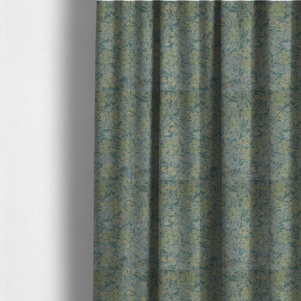 The fabric used for these made-to-measure curtains is a muted green textile print with a complex, repeating botanical motif. The design features tightly packed five-petal flower clusters and delicate willow-like leaves in shades of dusty sage, teal, and pale lime green.