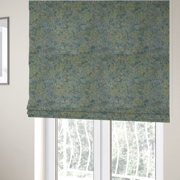 The fabric used to create these bespoke Roman blinds is a muted green textile print with a complex, repeating botanical motif. The design features tightly packed five-petal flower clusters and delicate willow-like leaves in shades of dusty sage, teal, and pale lime green.
