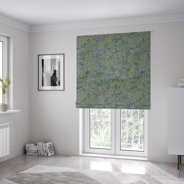 The fabric used to create these bespoke Roman blinds is a muted green textile print with a complex, repeating botanical motif. The design features tightly packed five-petal flower clusters and delicate willow-like leaves in shades of dusty sage, teal, and pale lime green.