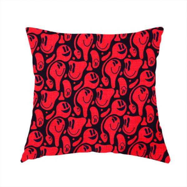 The fabric used for this handmade cushion is a repeating psychedelic pattern of vibrant red melting smiley faces and abstract kidney shapes set against a dark black background.
