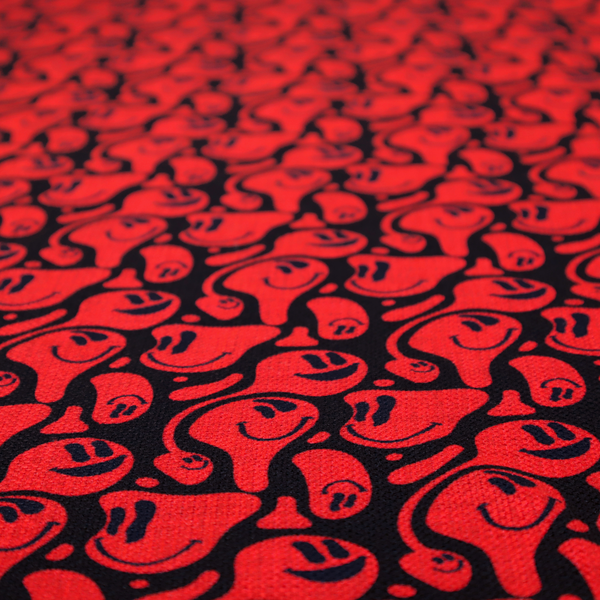 A repeating psychedelic pattern of vibrant red melting smiley faces and abstract kidney shapes set against a dark black background.